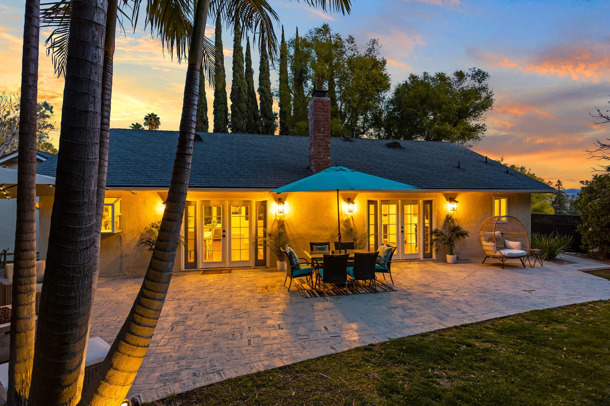 Twilight exterior showcasing architectural lighting and curb appeal