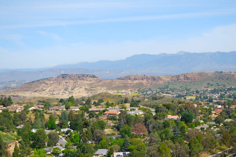 Mount Clef Ridge rising above tree filled Thousand Oaks neighborhoods on a sunny day