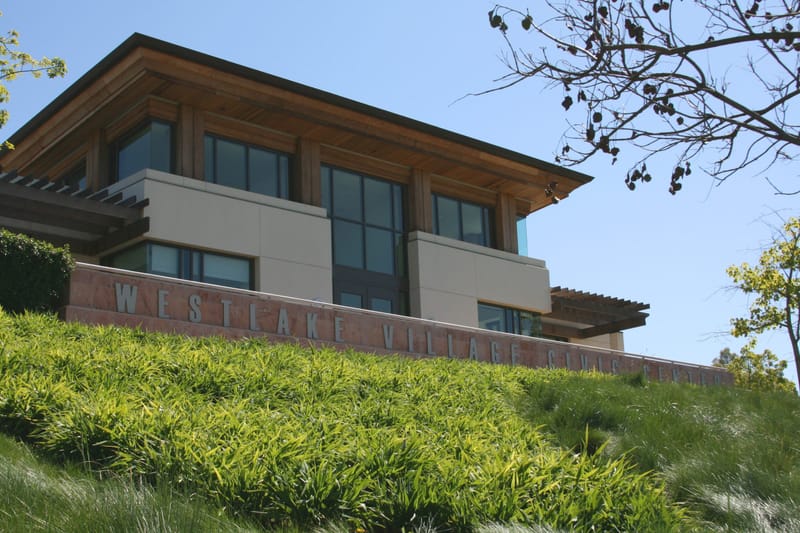 Westlake Village Civic Center building with lettered stone wall above a green landscaped slope