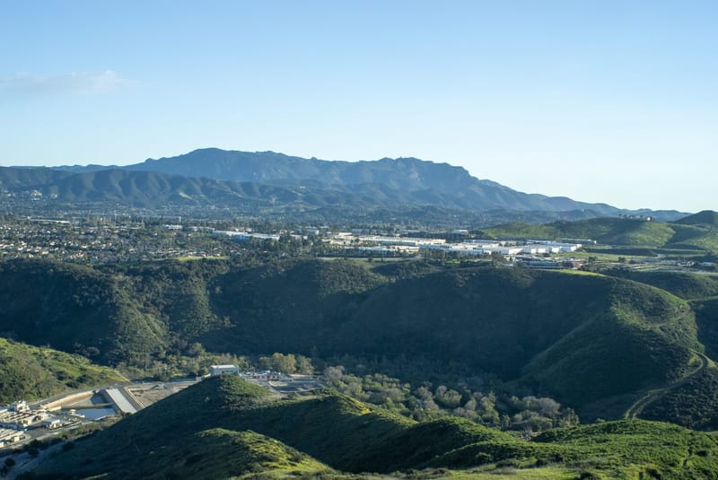 Green hills of Wildwood Park overlooking Thousand Oaks with Boney Mountain ridgeline beyond